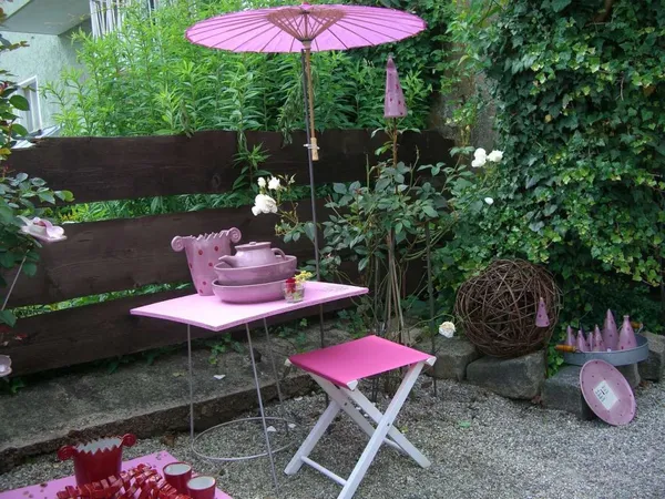 Show Your True Colors: This garden, with all its pink patio furniture, definitely belongs on the list of crazy garden ideas 