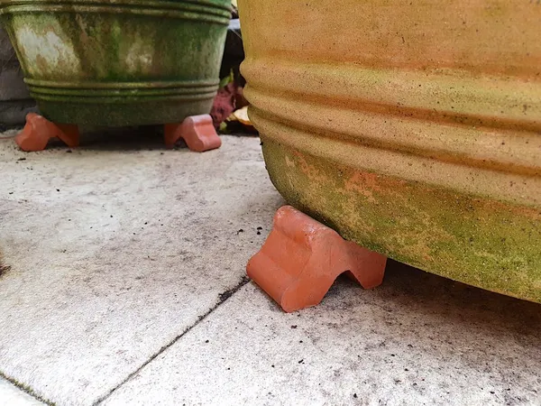 Place terracotta pots on stands and clean empty pots so they're ready for reuse