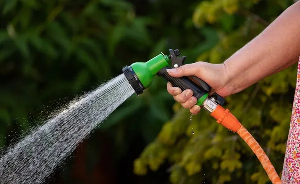Hose down the patio and tiles with water to clean them